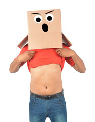 Young man gesturing with a cardboard box on his head with sad face isolated on white background