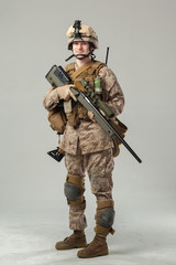 Soldier in camouflage holding rifle