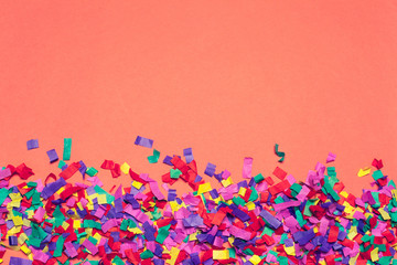 Fototapeta na wymiar Festive party decor and confetti on pink background