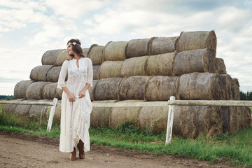 Woman wearing stylish white dress in the country side