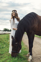 Cute young woman and her beautiful horse