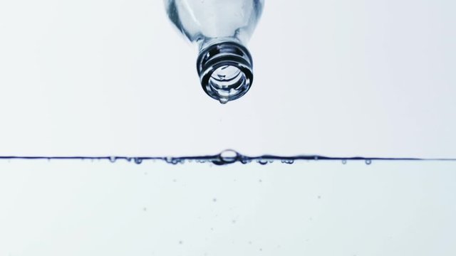 Cinemagraph. Drops of water drip from the neck of a bottle of water