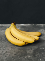 Bunch of bananas on a dark gray background