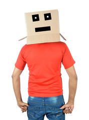 Young man gesturing with a cardboard box on his head with sad face isolated on white background