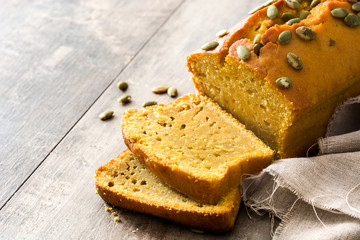Homemade pumpkin bread on wooden table. Copyspace