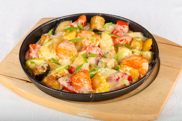 Baked salmon with potato in pan