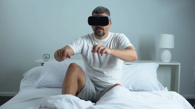 Man passing quest in virtual reality headset, modern technology, pastime at home