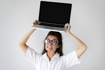 Young businesswoman with a laptop computer in her hands - obrazy, fototapety, plakaty