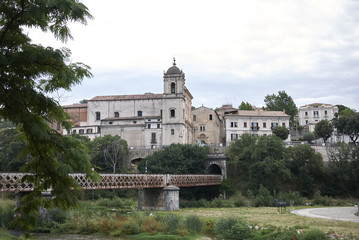 Fototapeta na wymiar Cosenza, Italy - June 13, 2018 : View of the railway bridge and San Domenico church in the background