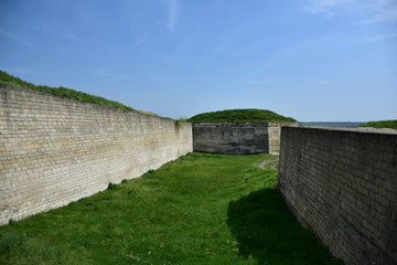 old stone fortress and green lawn