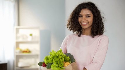 Smiling young lady with grocery bag, health and beauty, organic nutrition, food