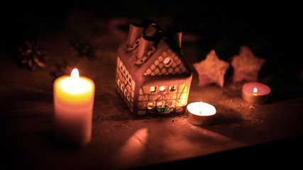 gingerbread house candle on blurred background of the table.