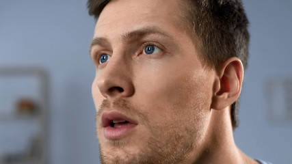 Obraz premium Serious male face, expression of hope, expectation, fan waiting for winning goal