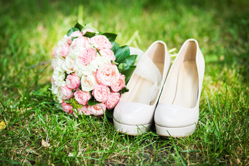 wedding shoes with elegant bride`s bouquet
