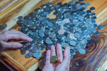 Many coins on a wooden table