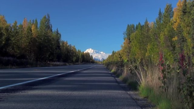 Zoom In From Road to Mt. McKinley as Bus Passes