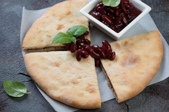 Sliced lobiani or georgian flatbread with red beans, selective focus, horizontal shot