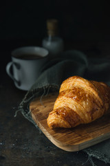 Croissant on rustic background