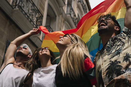 Group of friends with flag of pride