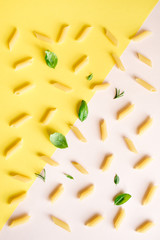Obraz premium Penne Pasta on pink and yellow