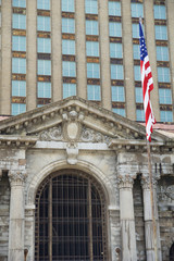 Fototapeta na wymiar DETROIT, MICHIGAN, UNITED STATES - MAY 5th 2018: A view of the old Michigan Central Station building in Detroit which served as a major railway depot from 1914 - 1988, detailed view with the american