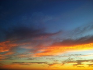 Beautiful sunset with contrast between yellow and the blue sky with clouds