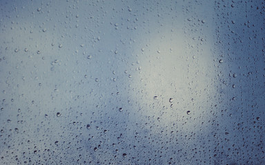 Beautiful colors on the glass soaked in the morning rains. You can see leaking drops on the glass.