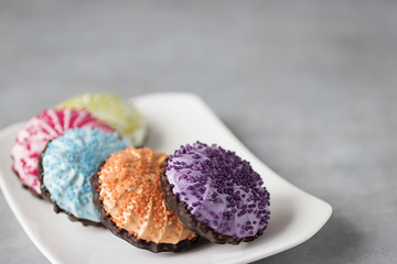 Multicolored marshmallow in white plate on  gray background. Russian sweets zefir.