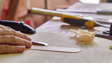 Marking and Pasting brace to the soundboard of a classical guitar. Production of classical guitar.