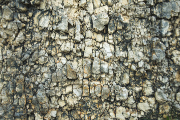 Obraz premium Textured stone background Rubble ballast in natural form in the rock wall