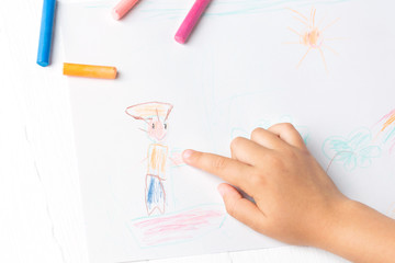 A girl draws a crayon, a pastel, a journey through the sea. Ship, sailor, boy, palm, sea