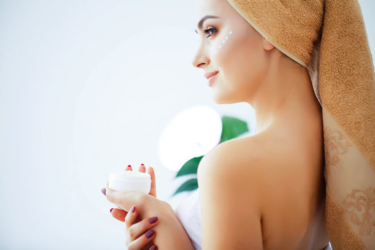Beauty and Care. Young Beautiful Girl Holding Face Cream. A Woman With Pure Skin. Skin Care. High Resolution