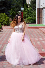 Fototapeta premium Beautiful girl in a lush pink dress