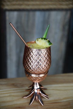 Tropical drink in pineapple shape copper cup