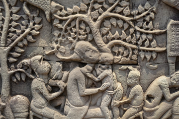 Ancient temple stone carved bas-relief in Angkor Wat. Mother and child bas-relief closeup. Angkor Wat Bayon temple