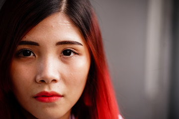Portrait of a young girl student with red hair in the campus