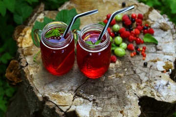summer drink. glass of compote with summer berries on natural background, Concept food homemade preserving organic ingredients for a recipe, outdoors