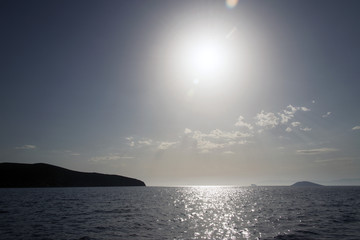 A view of a seascape and horizon under sunset in the island of Patmos, Greece