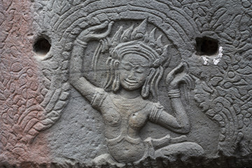 Ancient temple stone carved bas-relief in Angkor Wat. Dancing apsara woman bas-relief closeup. Angkor Wat temple