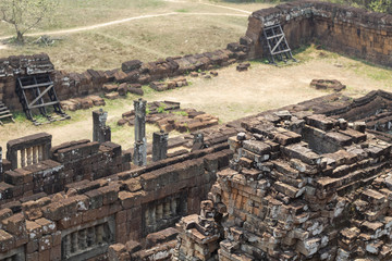 Ancient stone ruin in Angkor Wat temple. Stone brick masonry demolished. Khmer heritage temple ruin in jungle.