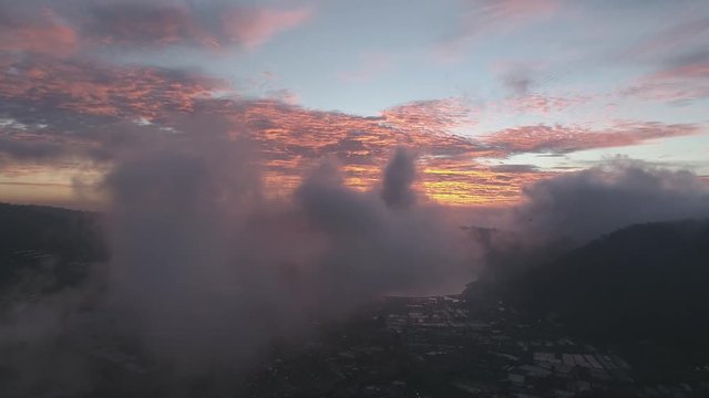 dreamy aerial shot high up in the clouds above lake bedugul in bali