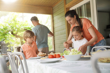 Obraz na płótnie Canvas Family on vacation preparing outdoor lunch