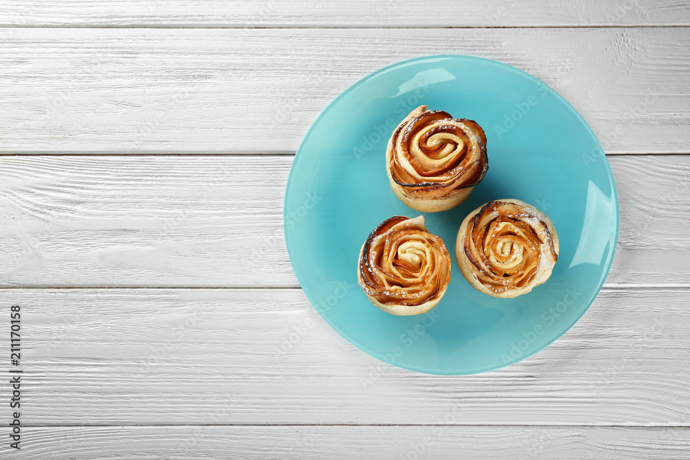 Sticker rose shaped pastry with apple filling on plate