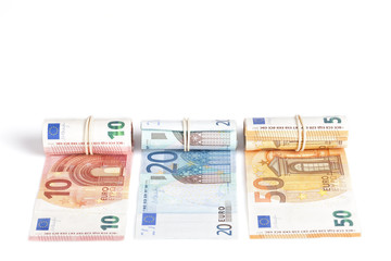 Euro bills rolled up and isolated on white