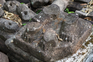 Ancient stone ruin in Angkor Wat temple. Animal paw statue debris closeup. Khmer heritage temple ruin in jungle.