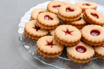 Traditional Christmas Linzer cookies with sweet jam on plate