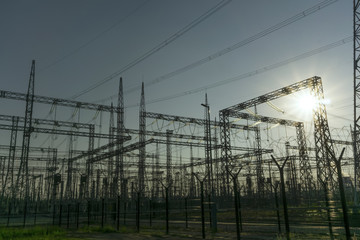 industrial background - graphical silhouettes of different structures of an electrical substation in a backlight