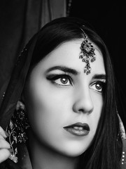 Beauty brunette Indian woman portrait. Hindu model girl with brown eyes. Close-up