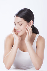 Fototapeta premium beautiful young caucasian woman with dark long hair being half naked, laughing, looking in camera with delight and happy face expression. Beauty and health.