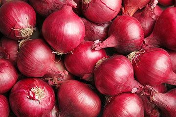 Ripe red onions as background